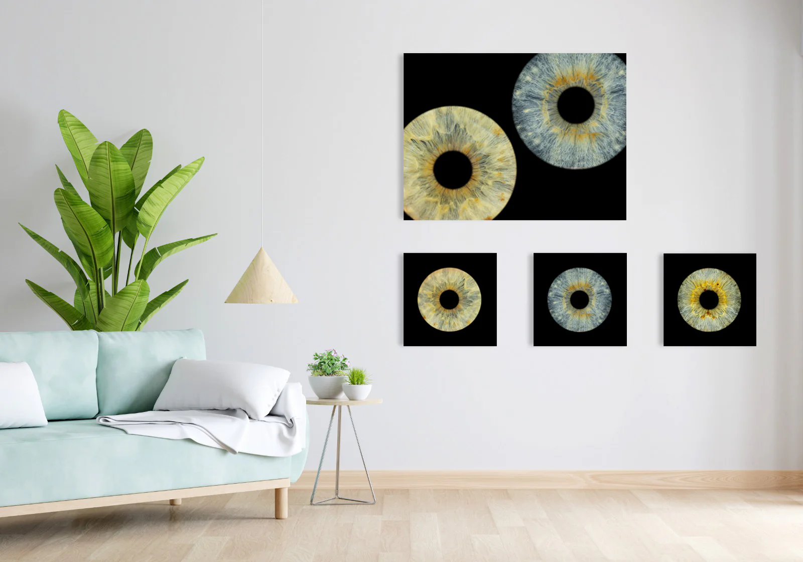 Modern living room with eye art gallery - light blue sofa, green plant, white wall with framed eye art